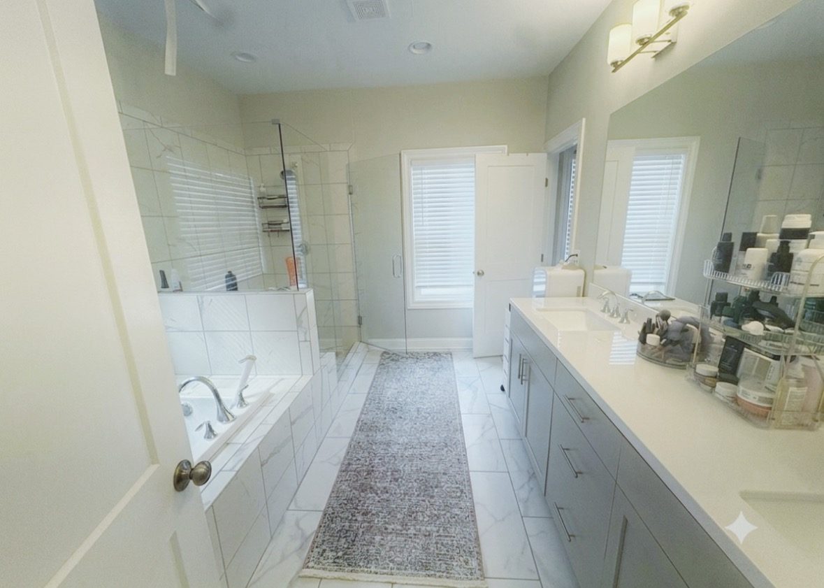 Primary bathroom with polished vanity, glass shower, and tub maintained by Haven Method